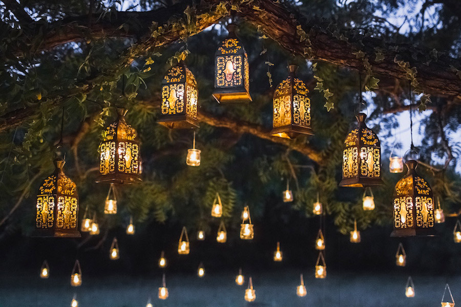 Lantern and candle lighting for outdoor party by Oleg Breslavtsev for Adobe Stock