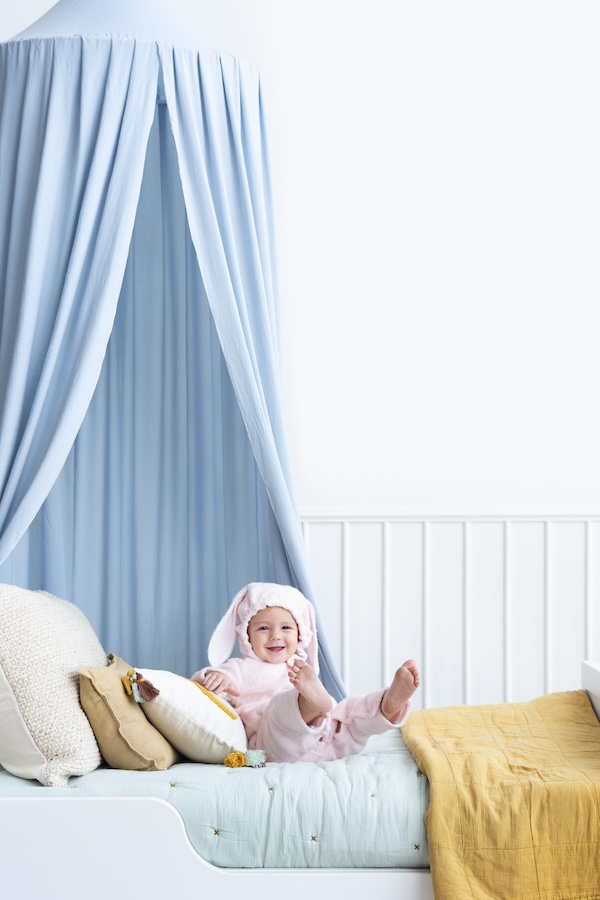 Baby in pastel bedroom